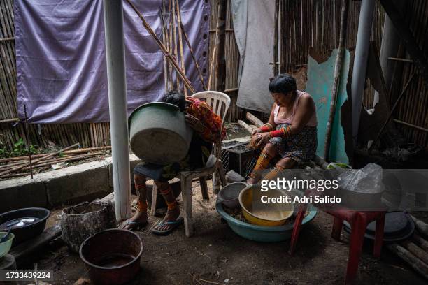 Women of the community dressed in traditional Kuna clothes prepare food on October 11, 2023 in Gardi Sugdub, Panama. Indigenous communities of the...