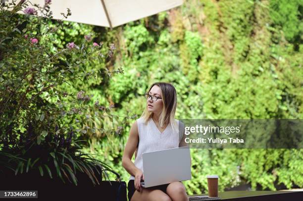 female scientist working on laptop. - glasshouse street stock pictures, royalty-free photos & images