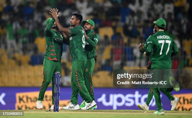 Mustafizur Rahman of Bangladesh celebrates the wicket of Rachin Ravindra of New Zealand during the ICC Men's Cricket World Cup India 2023 between New...