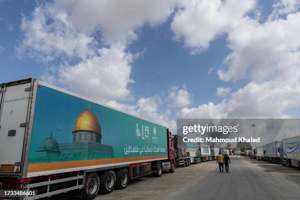 Aid convoy trucks wait at the Rafah border crossing for clearance to enter Gaza on October 19, 2023 in North Sinai, Egypt. The aid convoy, organized...