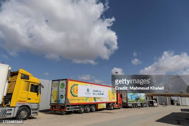 Aid convoy trucks wait at the Rafah border crossing for clearance to enter Gaza on October 19, 2023 in North Sinai, Egypt. The aid convoy, organized...