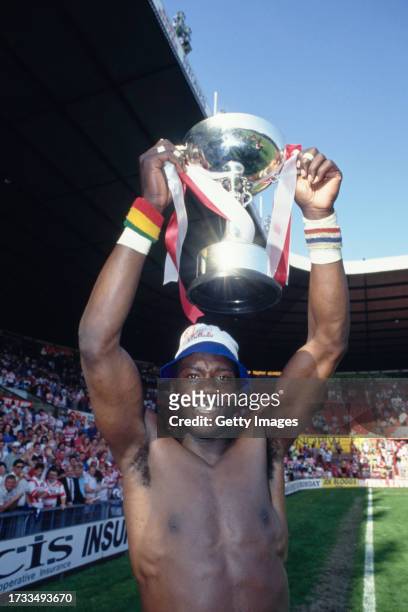 Wigan wing Martin Offiah celebrates with the trophy after Wigan had beaten St Helens to win the Rugby League Premiership on May 17th, 1992 in...