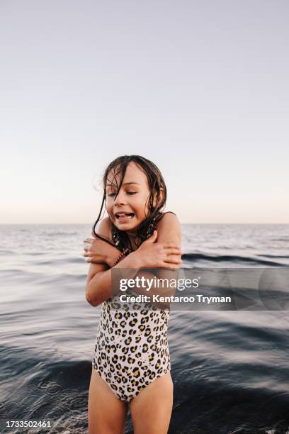 portrait of a girl at a beach that is freezing. - girl shivering stock pictures, royalty-free photos & images