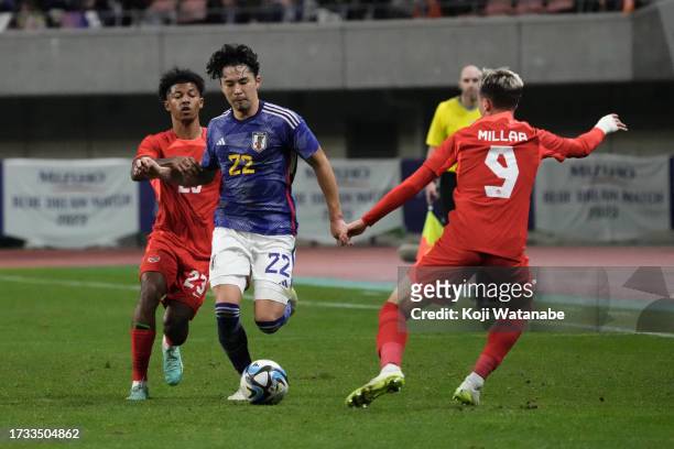 Yuta Nakayama of Japan competes for the ball against Charles-Andreas Brym and Liam Millar of Canada during the international friendly match between...
