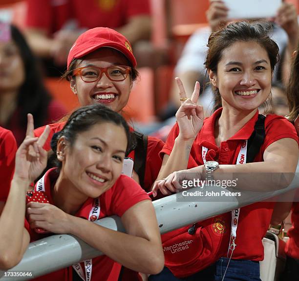 Manchester United fans watch from the stand during a first team training session at Rajmalanga Stadium as part of their pre-season tour of Bangkok,...