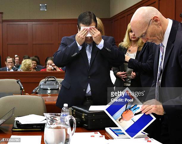 Defendant George Zimmerman wipes his face after arriving in the courtroom for closing aurguments in his murder trial as defense counsel Don West...