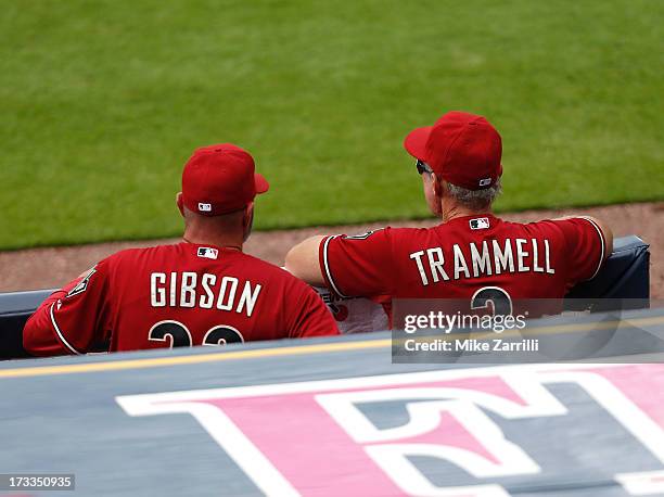 Manager Kirk Gibson and bench coach Alan Trammell of the Arizona Diamondbacks watch the action on the field from the dugout during the game against...