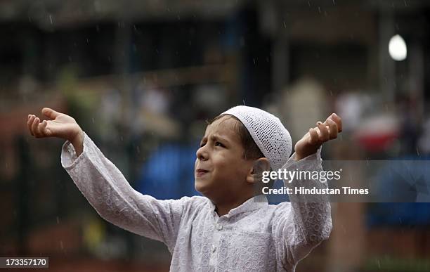 Muslim boy enjoy monsoon rain at Jama Masjid on July 12, 2013 in New Delhi, India. India's monsoon rains were 5 percent below average in the week...