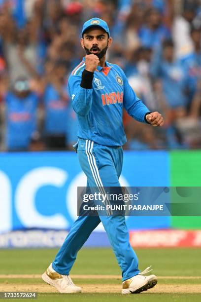 India's Virat Kohli celebrates after the dismissal of Bangladesh's Mushfiqur Rahim during the 2023 ICC Men's Cricket World Cup one-day international...