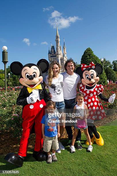 In this handout photo provided by Disney Parks, Carlos Vives, his wife Claudia and children Elena and Pedro visit Walt Disney World on July 9, 2013...