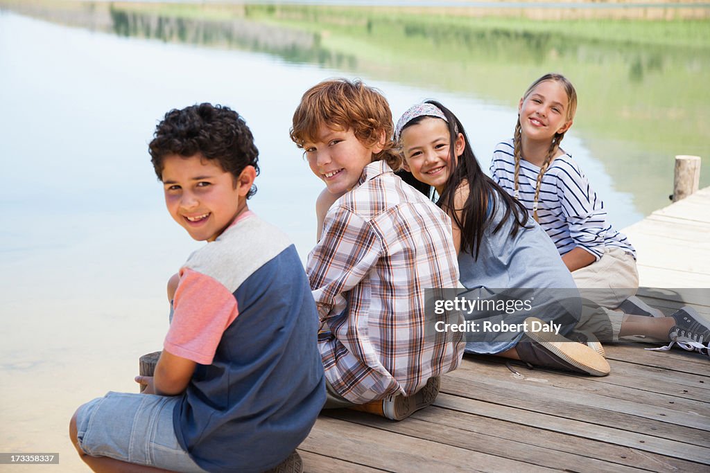 Portrait of kids sitting on dock