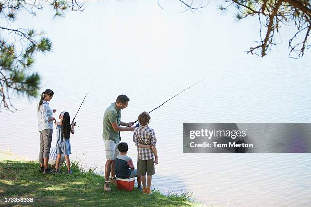 family fishing lakeside - kids fishing stock pictures, royalty-free photos & images