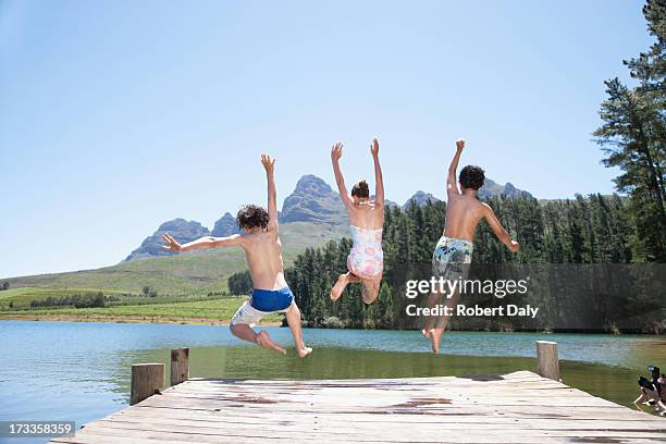 kids jumping off dock into lake - preteen girl no shirt stock pictures, royalty-free photos & images