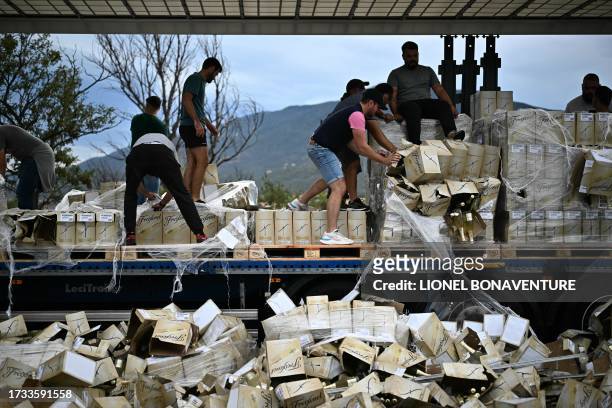 Winegrowers destroy bottles of wine on a lorry during a road blocking demonstration to protest against imports of Spanish wine, on the motorway at...