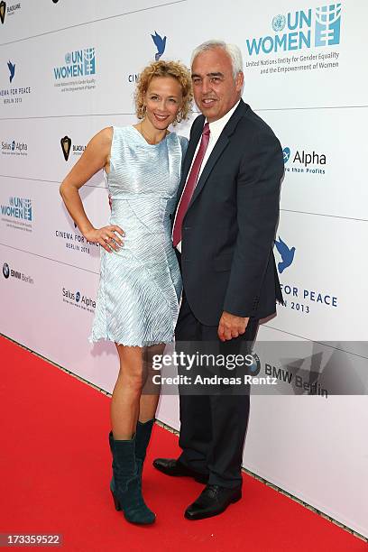 Katja Riemann and Hans-Rainer Schroeder arrive for the Cinema for Peace UN women honorary dinner at Soho House on July 12, 2013 in Berlin, Germany.