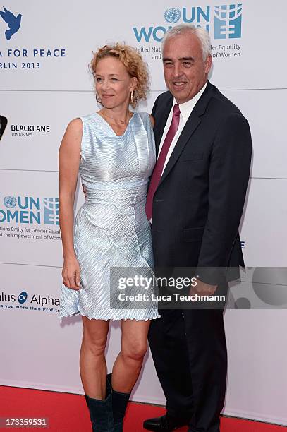 Katja Riemann and Hans-Rainer Schroeder arrive for the Cinema for Peace UN women honorary dinner at Soho House on July 12, 2013 in Berlin, Germany.