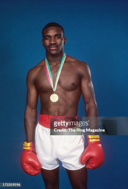 Olympian Evander Holyfield poses for a portrait with his medal.