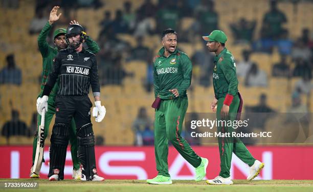 Shakib Al Hasan of Bangladesh celebrates the wicket of Devon Conway of New Zealand during the ICC Men's Cricket World Cup India 2023 between New...