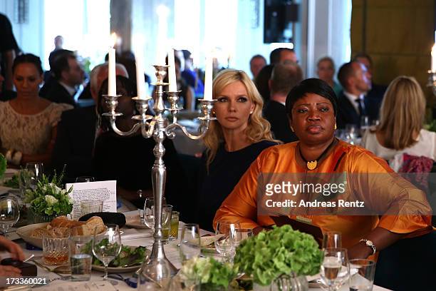 Veronica Ferres and Fatou Bensouda attends the Cinema for Peace UN women charity dinner at Soho House on July 12, 2013 in Berlin, Germany.