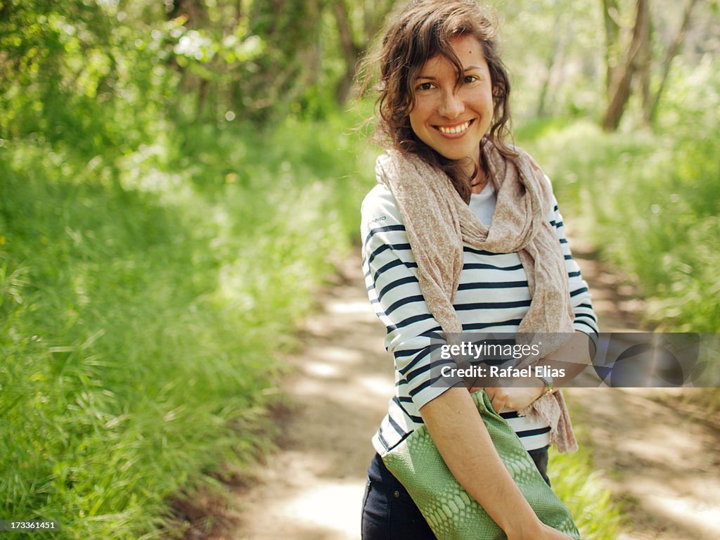 Pretty woman standing on path in nature