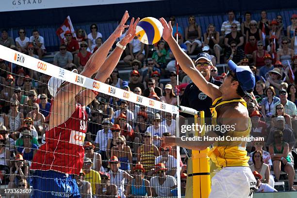 Switzerland's Philip Gabathuler defends as Italy's Daniele Lupo attacks during the Nicolai-Lupo v Gabathuler-Weingart game as part of the FIVB Gstaad...