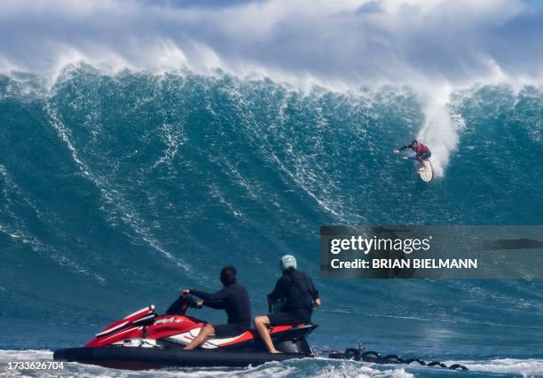 Surfer Steve Roberson rides a wave as a big swell hits Pe'ahi surfing break, known as Jaws, on the north shore of the island of Maui, Hawaii on...