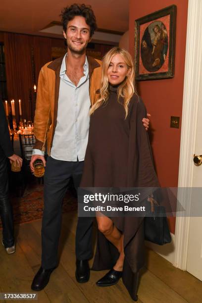 Oli Green and Sienna Miller attend the Haider Ackermann x Augustinus Bader x Tish Weinstock dinner on October 12, 2023 in London, England.