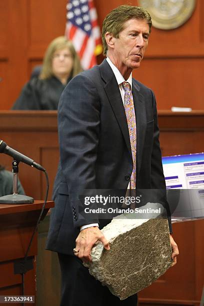 Mark O'Mara, defense attorney for George Zimmerman, carries a slab of concrete toward the jury during closing arguments in Zimmerman's trial in...