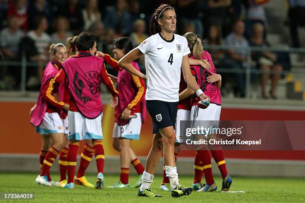The team of Spain celebrates the 3-2 victory and Jill Scott of England looks dejected after the UEFA Women's EURO 2013 Group C match between England...