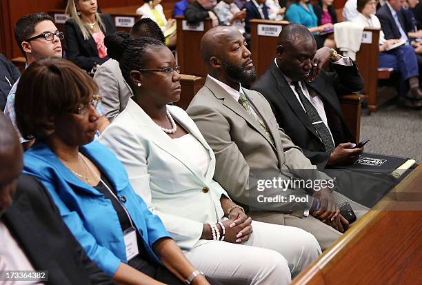 Sabrina Fulton and Tracy Martin , Trayvon Martin's parents, and family lawyer Benjamin Crump sit in court during George Zimmerman's murder trial July...