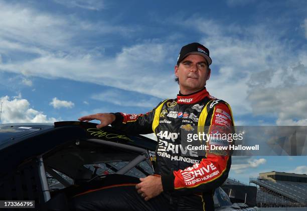 Jeff Gordon, driver of the Drive To End Hunger Chevrolet, climbs from his car after qualifying for the NASCAR Sprint Cup Series Camping World RV...