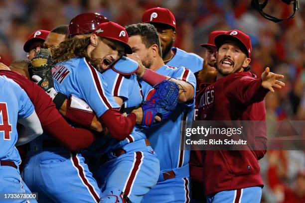 Matt Strahm and J.T. Realmuto of the Philadelphia Phillies celebrate after beating the Atlanta Braves 3-1 in Game Four of the Division Series at...