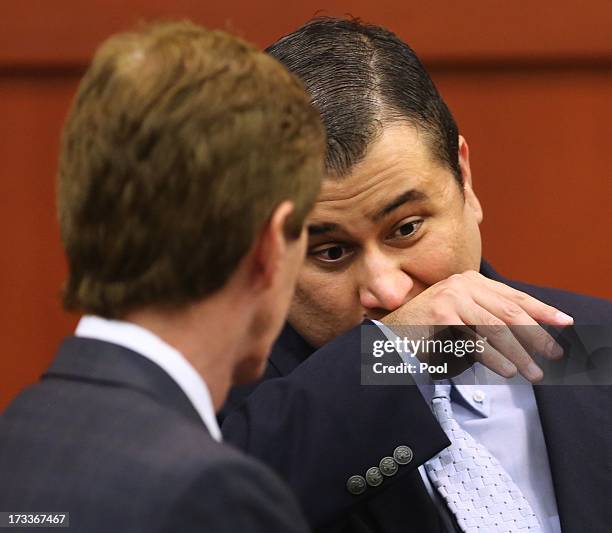 George Zimmerman wipes his face as he chats with Defense counsel Mark O'Mara after Judge Debra Nelson announced the jury wants to break deliberations...