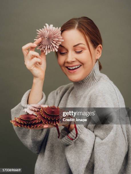 woman holding christmas decoration ornaments in pastel paper natural color scheme - pink colour scheme stock pictures, royalty-free photos & images