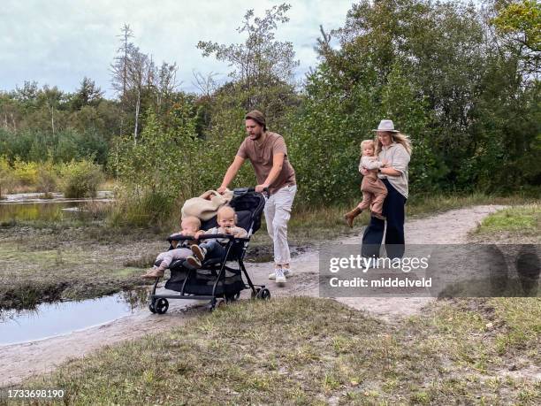 young family having a holiday walk in the heath - huis ter heide stockfoto's en -beelden