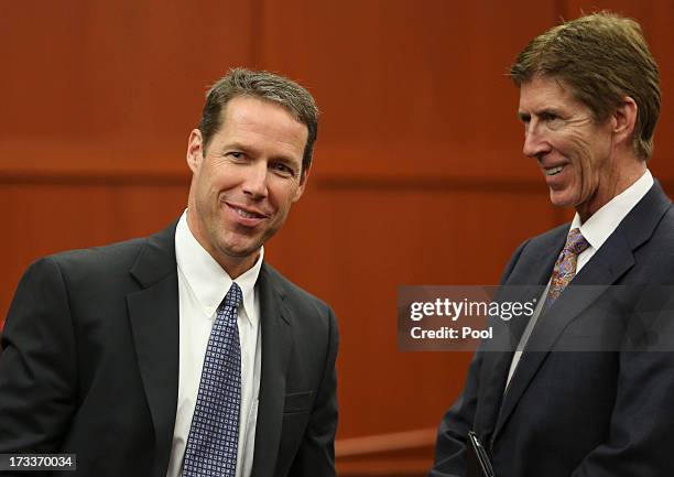 Assistant state attorney John Guy , and defense attorney Mark O'Mara laugh at the end of the day during George Zimmerman's trial in Seminole circuit...