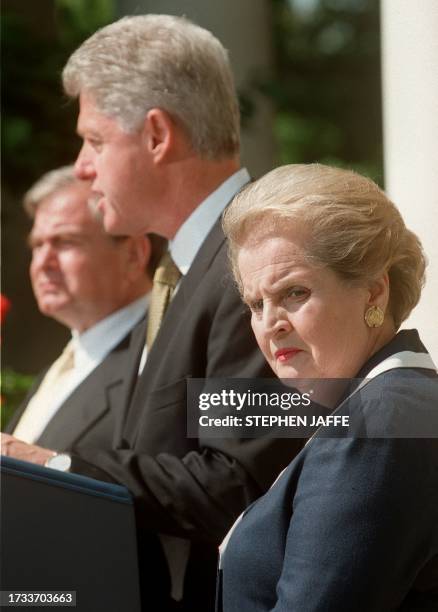 Secretary of State Madeleine Albright looks on with National Security Advisor Sandy Berger as US President Bill Clinton speaks to reporters 03 June...