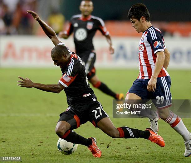 Guadalajara midfielder Michael Perez sends D.C. United midfielder Sainey Nyassi to the pitch during second-half action in an international club...