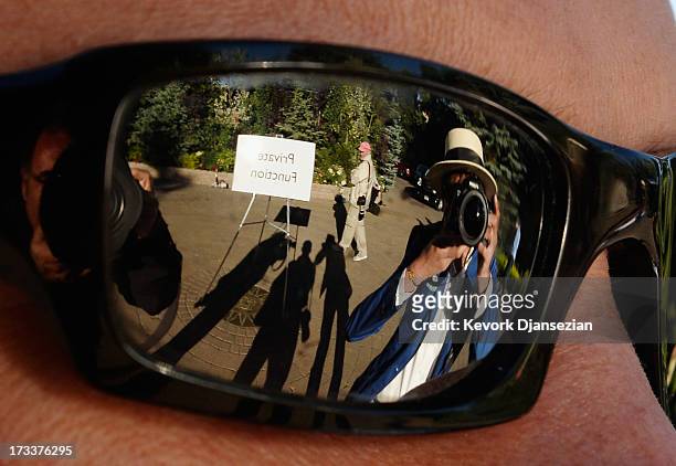 The entrance of Sun Valley Inn is reflected in a news photographers shades during Allen & Co.'s annual conference on July 12, 2013 in Sun Valley,...