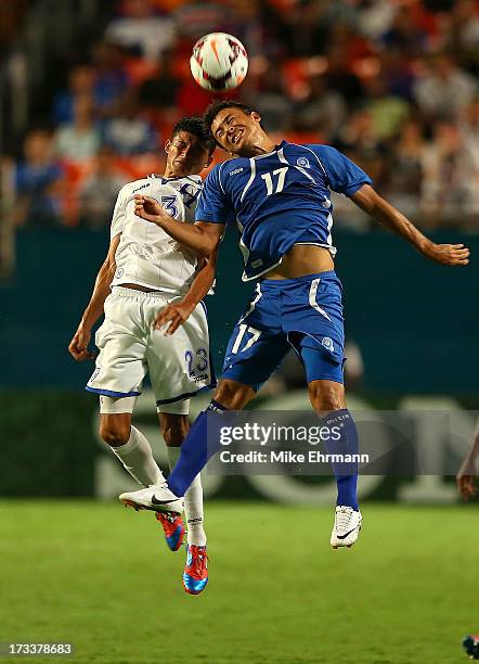 Lester Blanco Pineda of EL Salvador goes for a header against Edder Delgado Zeron of Honduras during a CONCACAF Gold Cup game at Sun Life Stadium on...