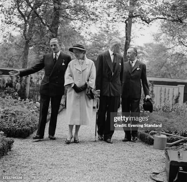 French horticulturist André De Vilmorin with his wife Andrée , garden designer Russell Page and Roger de Vilmorin at the Chelsea Flower Show, London,...