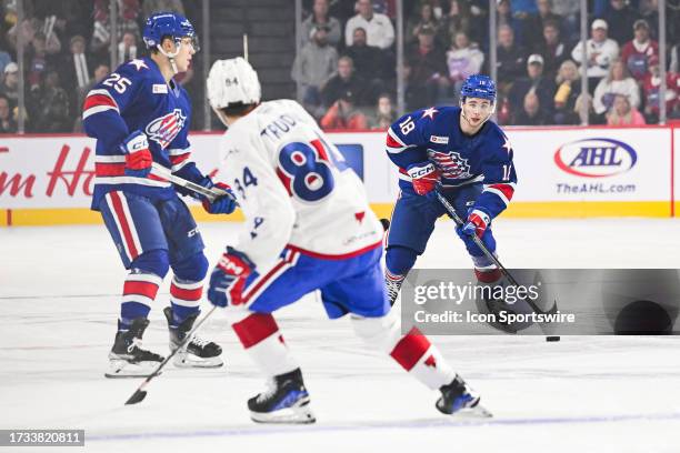 Rochester Americans right wing Isak Rosen plays the puck during the game between the Rochester Americans versus the Laval Rocket on October 18, 2023...