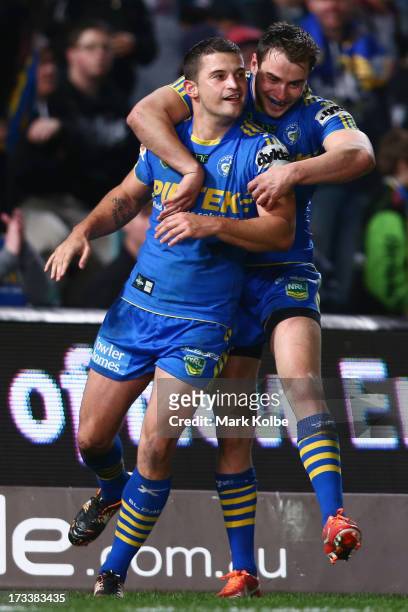 Luke Kelly of the Eels is congratulated by his team mate Ryan Morgan of the Eels after scoring a try during the round 18 NRL match between Parramatta...