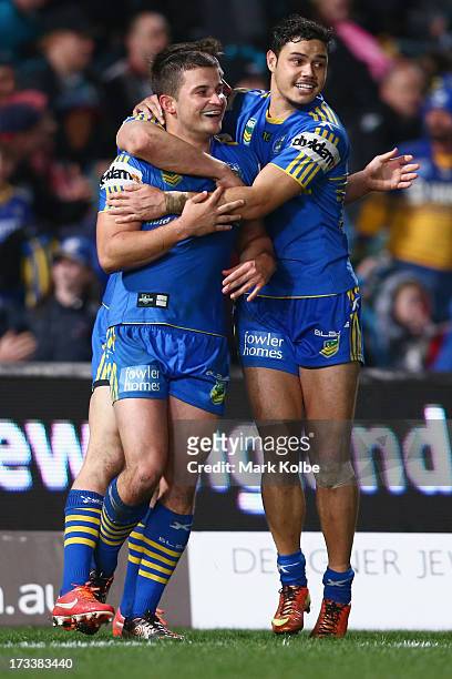 Luke Kelly of the Eels is congratulated by his team mate Brayden Wiliame of the Eels after scoring a try during the round 18 NRL match between...