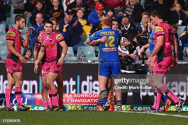 Brayden Wiliame of the Eels is congratulated by his team mate Daniel Harrison of the Eels after scoring a try during the round 18 NRL match between...