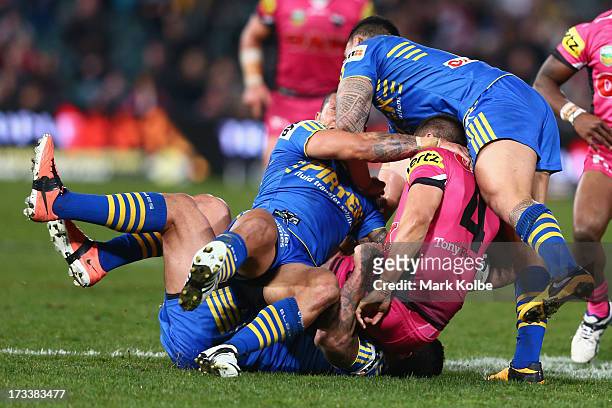 Dean Whare of the Panthers is tackled during the round 18 NRL match between Parramatta Eels and the Penrith Panthers at Parramatta Stadium on July...