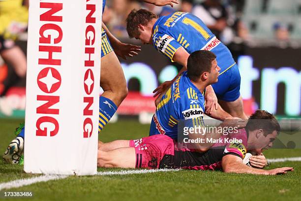Kevin Kingston of the Panthers dives over to score a try during the round 18 NRL match between Parramatta Eels and the Penrith Panthers at Parramatta...