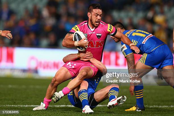 Isaac John of the Panthers is tackled during the round 18 NRL match between Parramatta Eels and the Penrith Panthers at Parramatta Stadium on July...