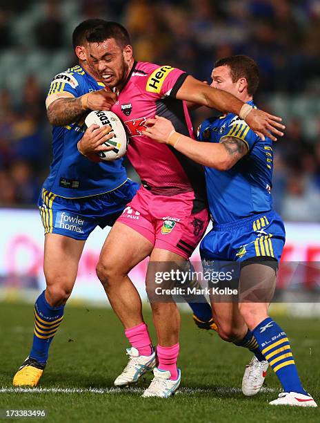 Isaac John of the Panthers is tackled during the round 18 NRL match between Parramatta Eels and the Penrith Panthers at Parramatta Stadium on July...