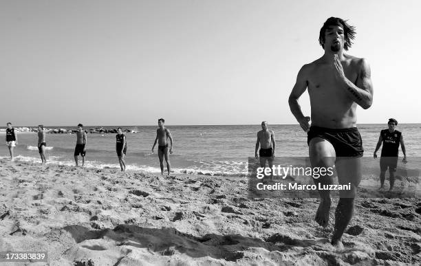 Amauri Carvalho De Oliveira of Parma FC runs on the beach during Parma FC Pre-Season Training Session at Rosa Marina Resort on July 13, 2013 in...